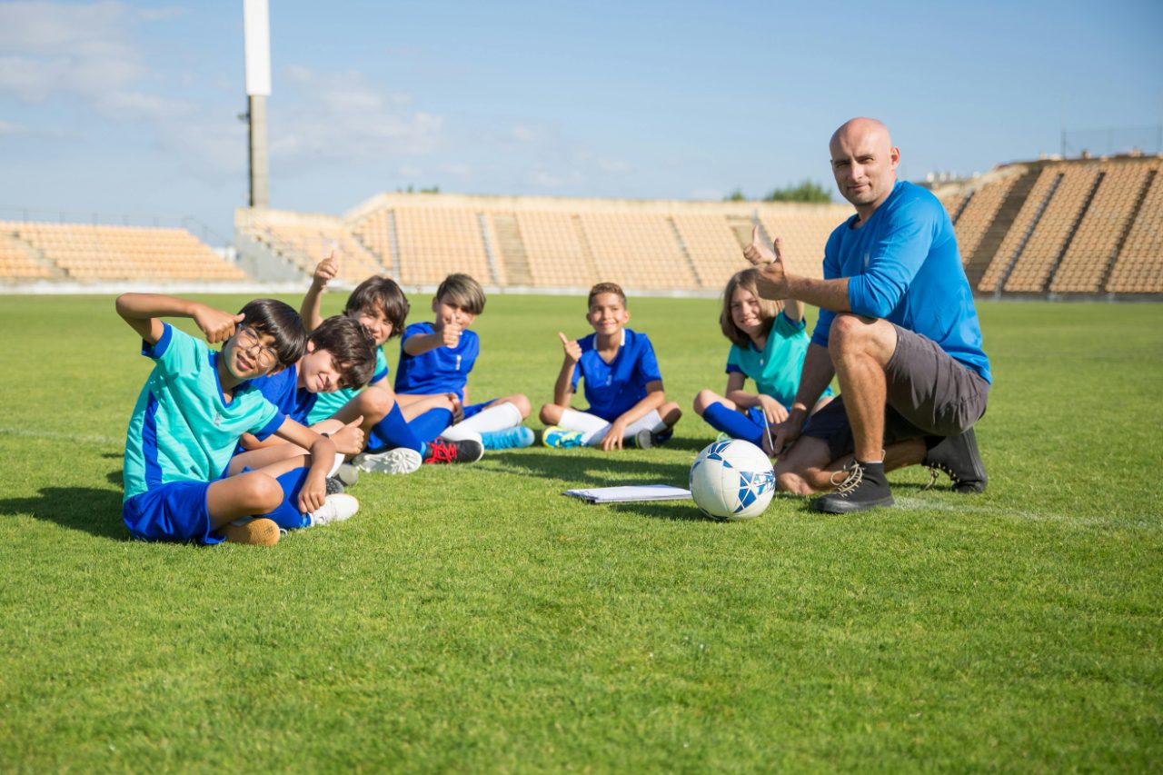 Youth football team with coach