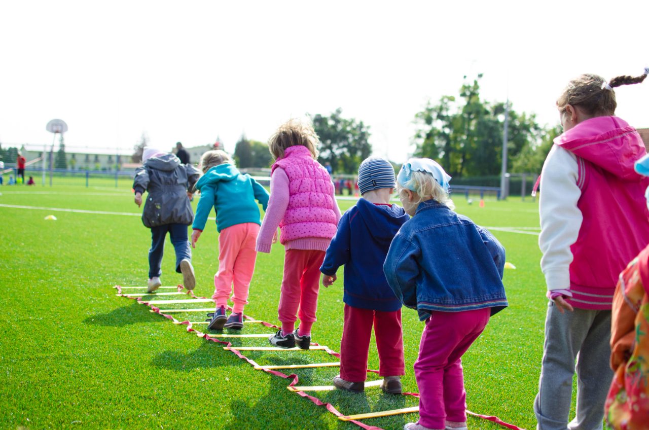 Children moving through an agility ladder drill